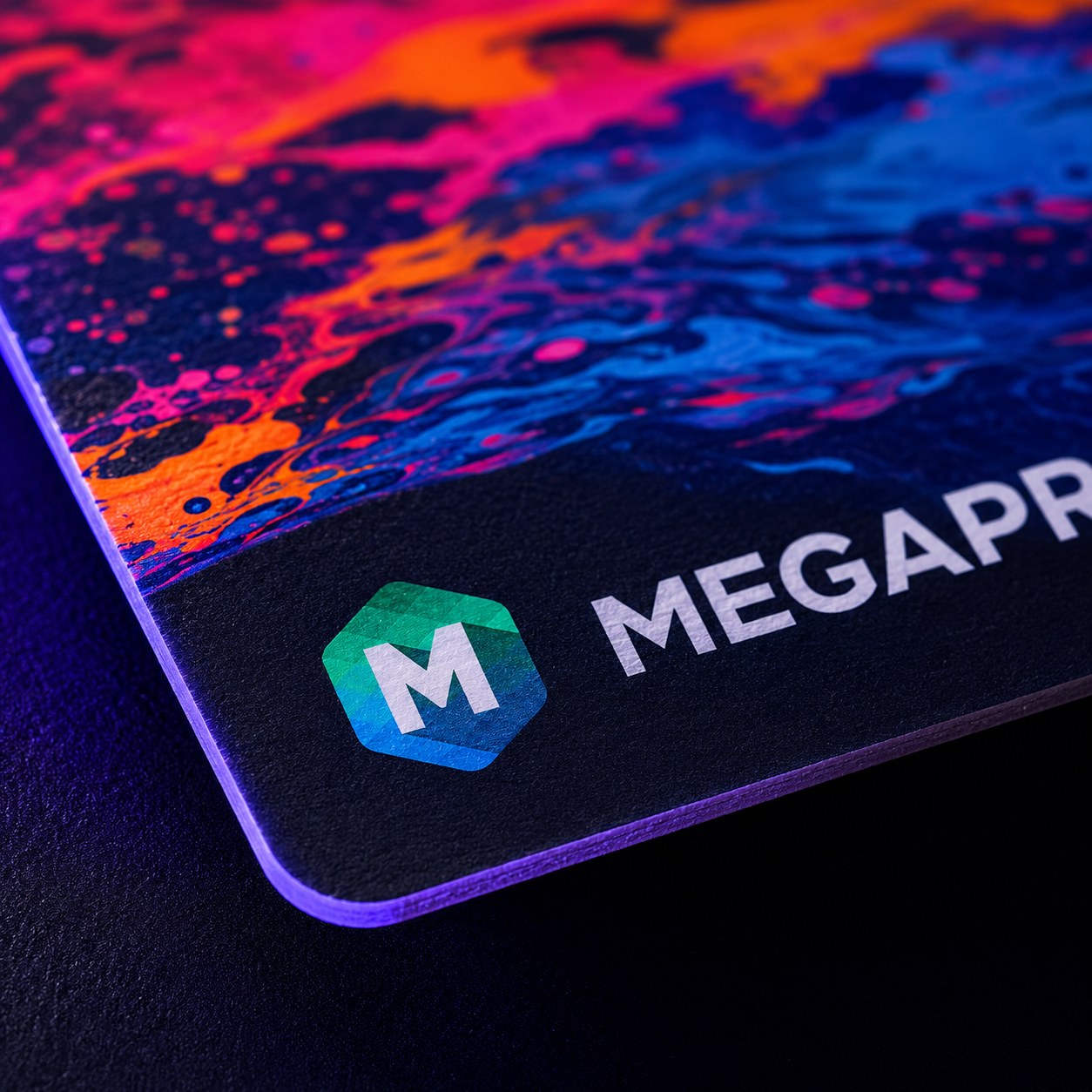 Macro close-up of a Megaprint business card corner showing vivid full-color print and the Megaprint logo